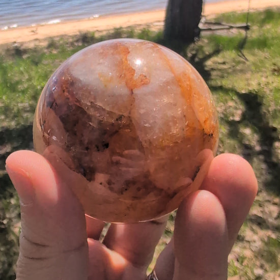 Video showcase of premium Golden Healer quartz spheres from Brazil in natural daylight.