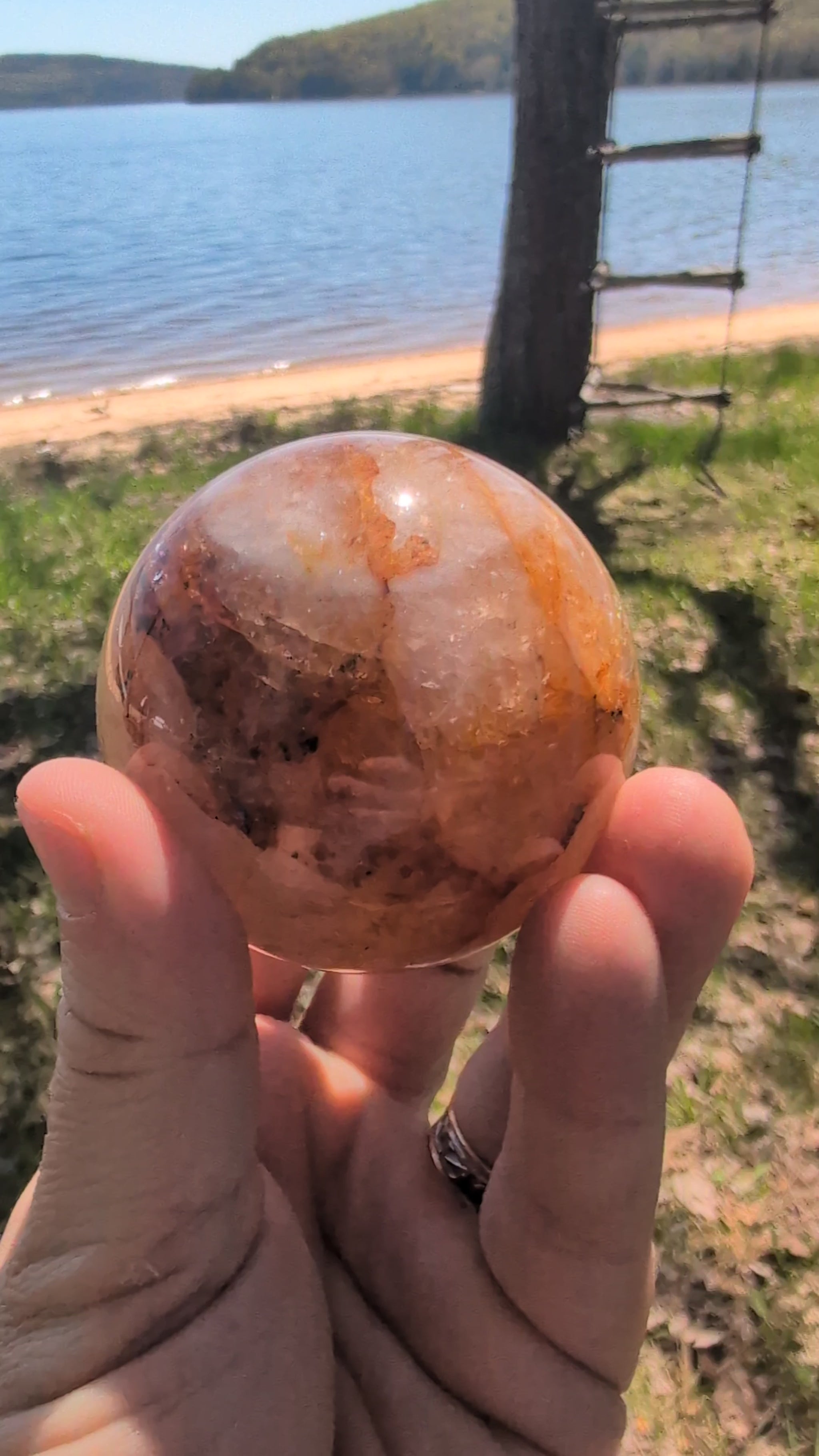 Video showcase of premium Golden Healer quartz spheres from Brazil in natural daylight.