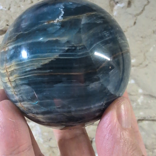 360° video of 70mm blue calcite sphere with golden banding