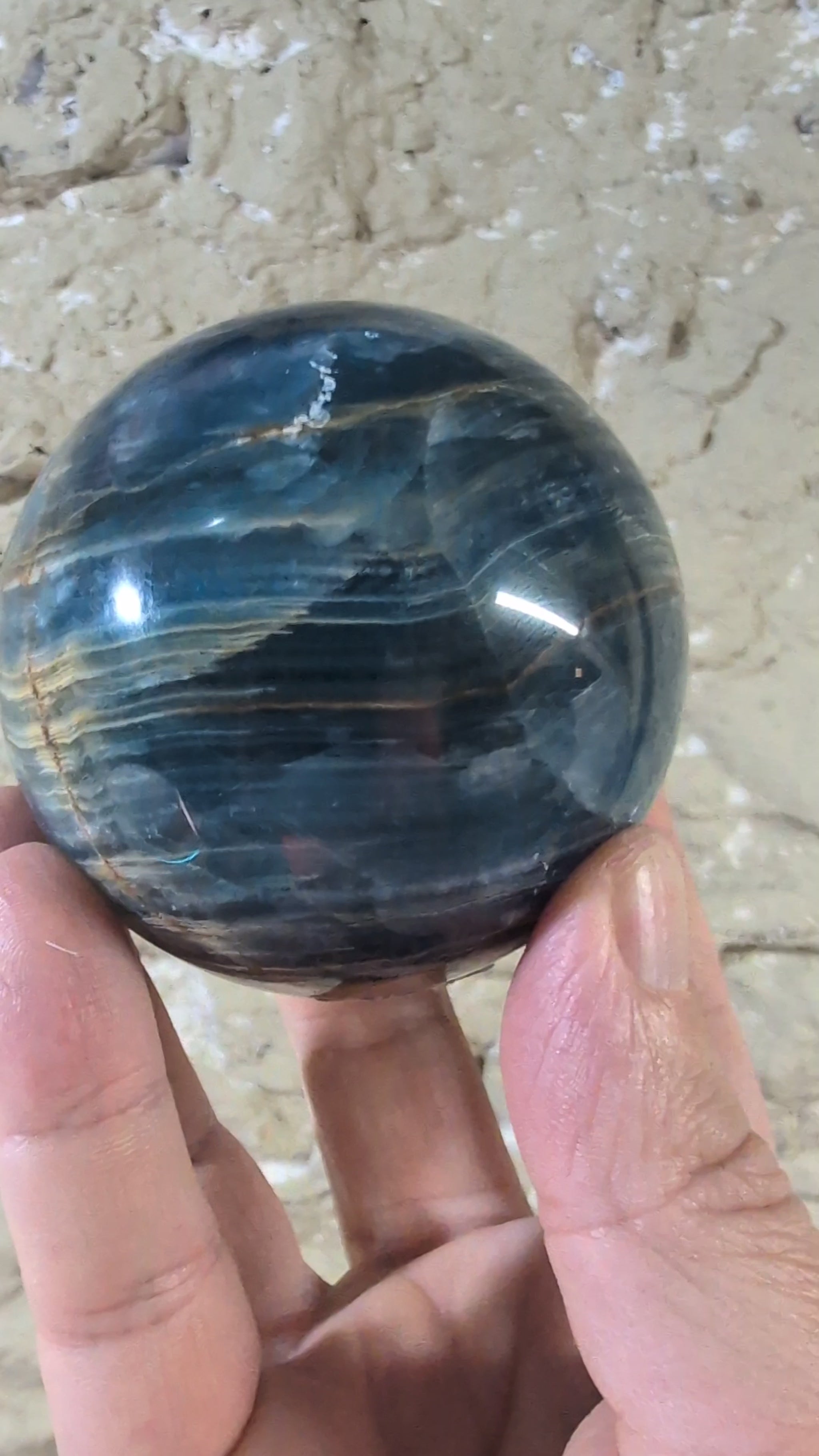 360° video of 70mm blue calcite sphere with golden banding