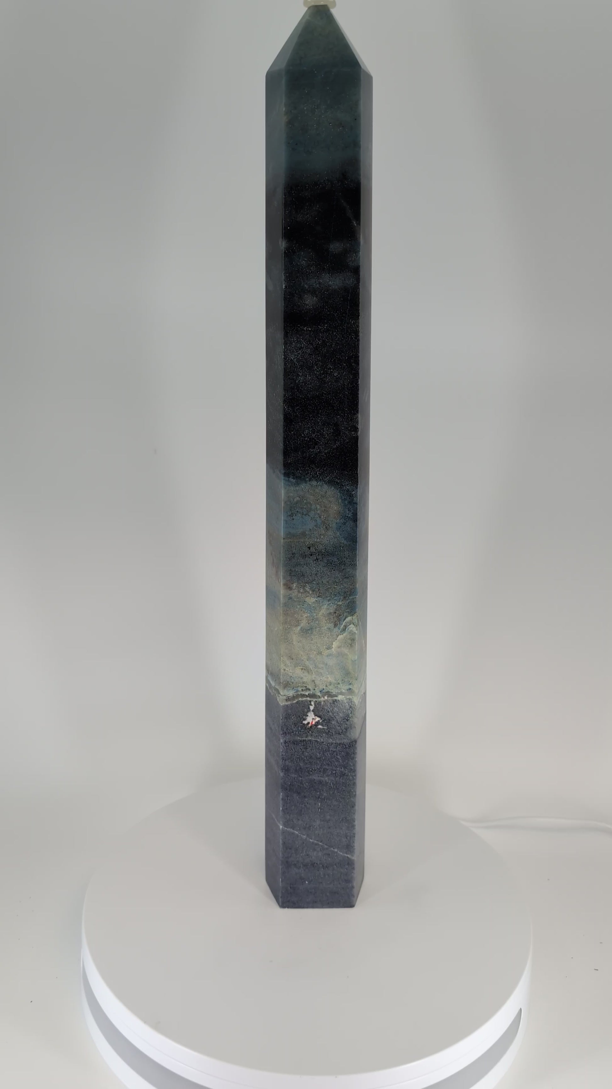 360-degree video of Trollite Tower TR-02 — an 18-inch (46 cm) polished blue-green crystal tower from Minas Gerais, Brazil, showing vertical color transitions, reflective polish, and natural mica shimmer under studio light.