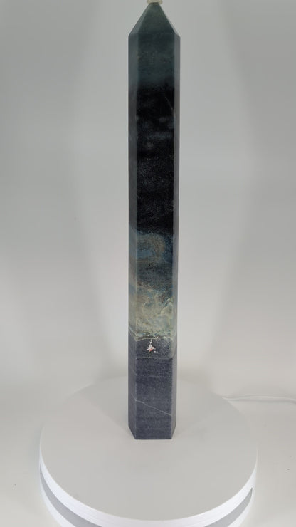 360-degree video of Trollite Tower TR-02 — an 18-inch (46 cm) polished blue-green crystal tower from Minas Gerais, Brazil, showing vertical color transitions, reflective polish, and natural mica shimmer under studio light.