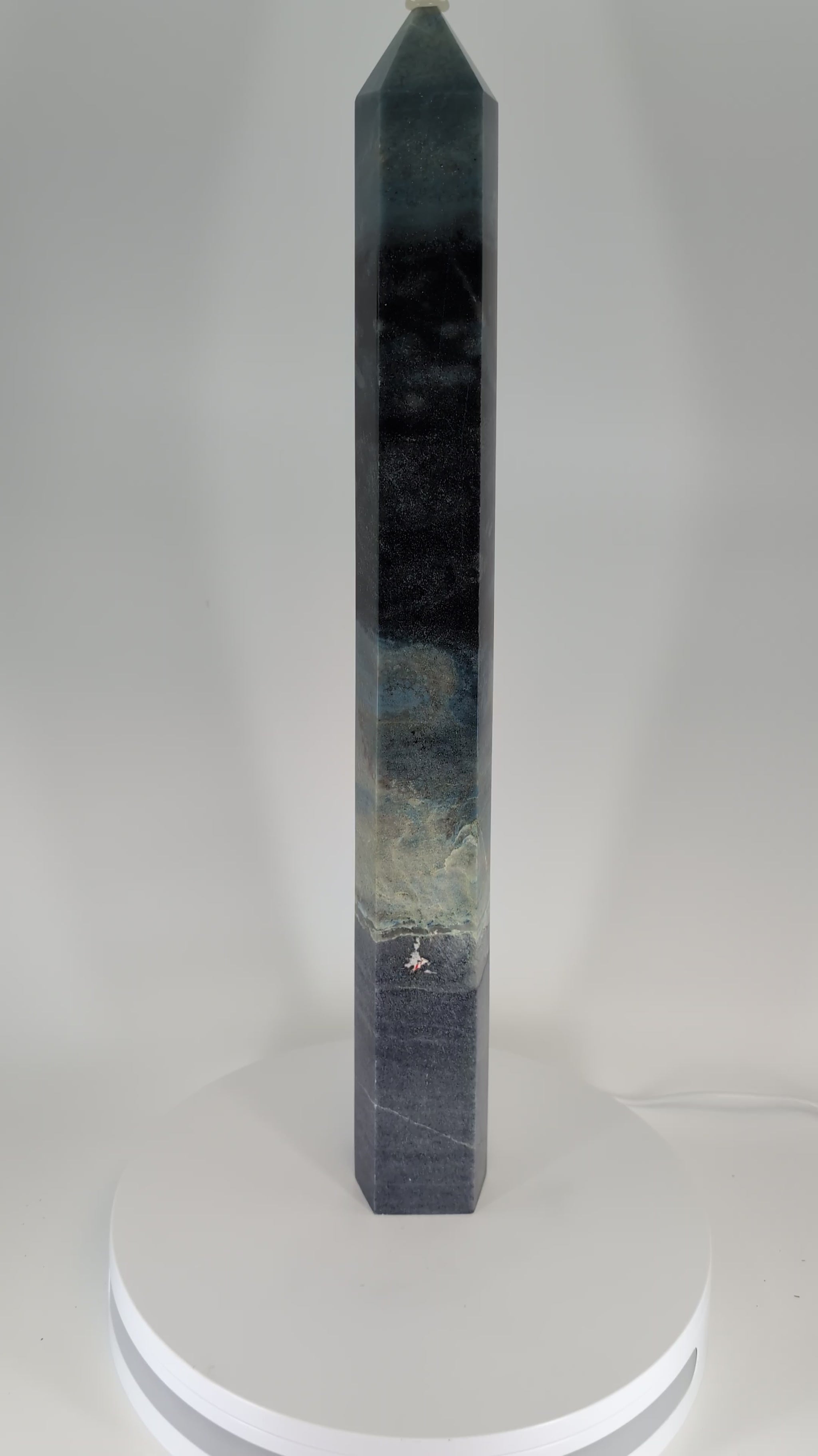 360-degree video of Trollite Tower TR-02 — an 18-inch (46 cm) polished blue-green crystal tower from Minas Gerais, Brazil, showing vertical color transitions, reflective polish, and natural mica shimmer under studio light.