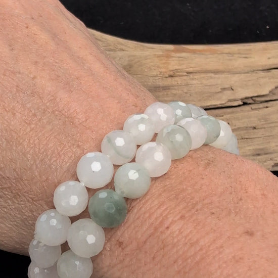 Video showcasing the highly reflective faceted texture and soft, milky-white and pale green translucency of an 8mm White Jade (Quartzite) beaded stretch bracelet worn on a wrist.