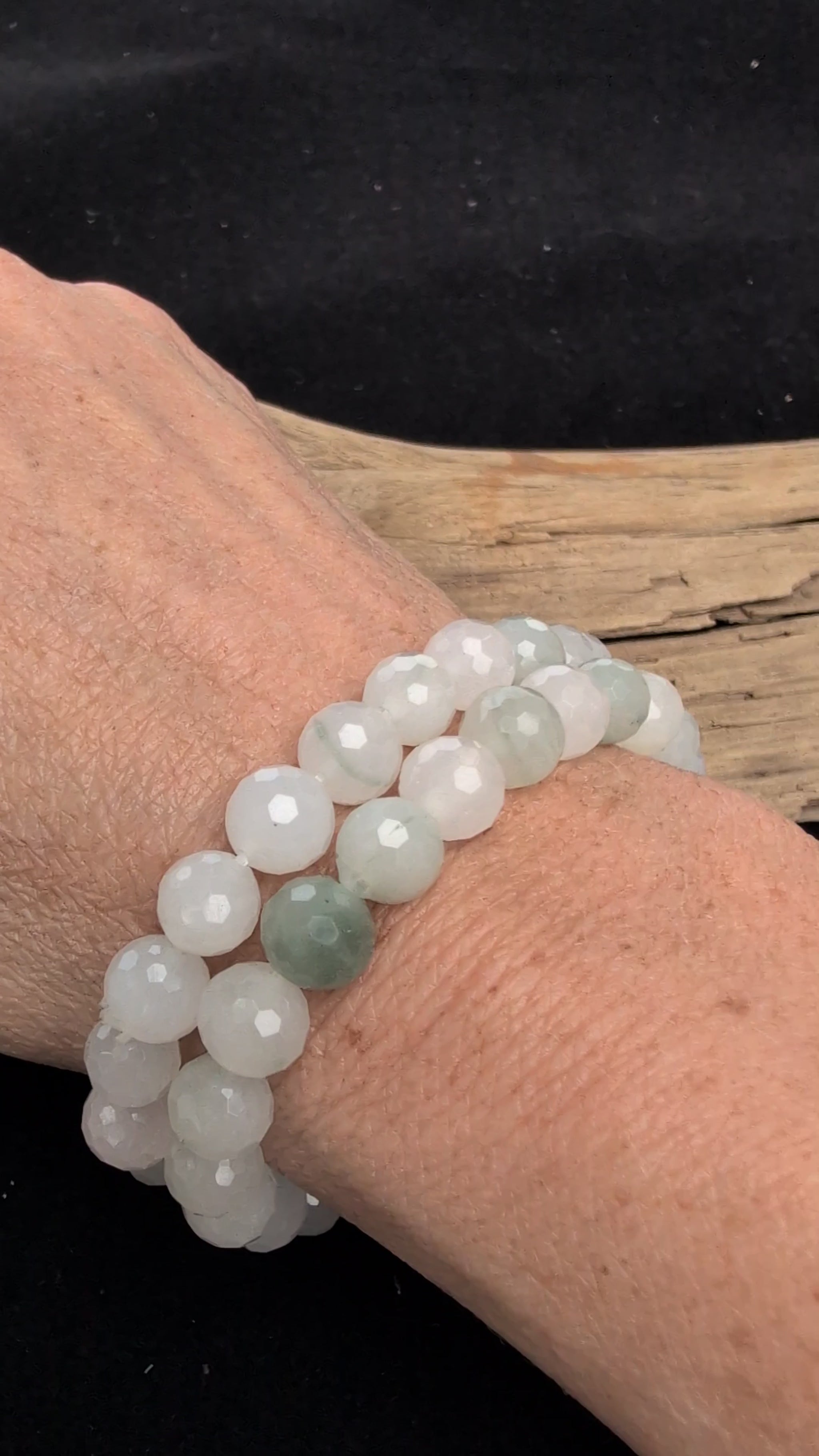 Video showcasing the highly reflective faceted texture and soft, milky-white and pale green translucency of an 8mm White Jade (Quartzite) beaded stretch bracelet worn on a wrist.