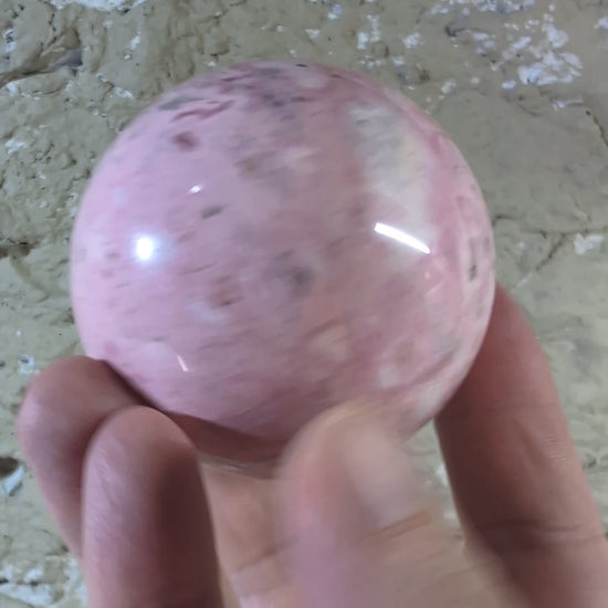 Video of 60 mm 500 g Pink Peruvian Rhodonite sphere