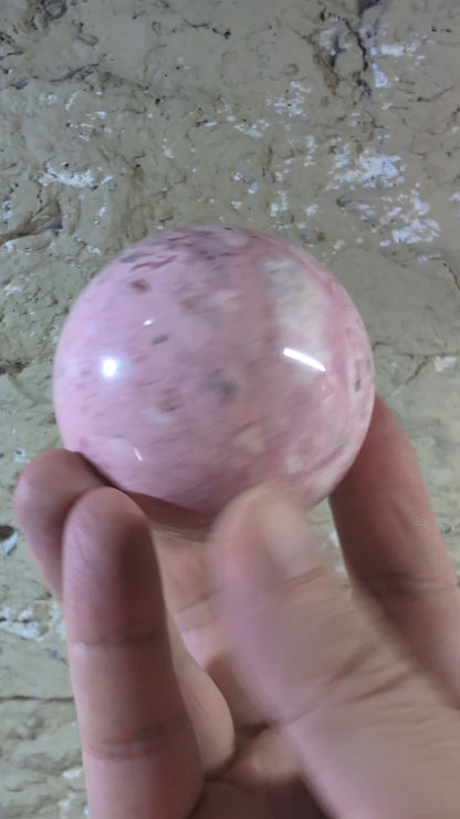 Video of 60 mm 500 g Pink Peruvian Rhodonite sphere