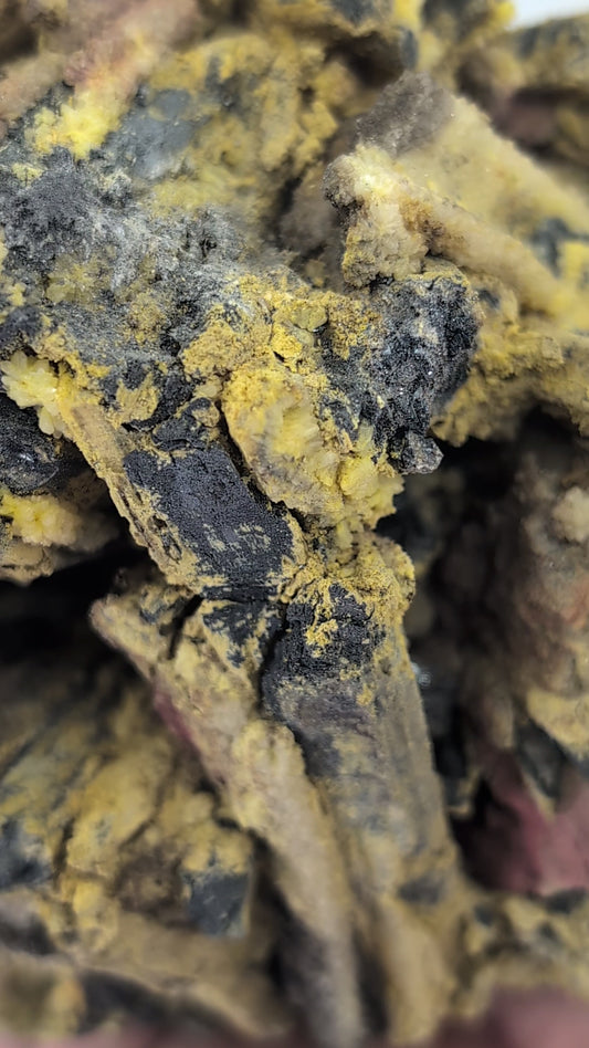 A rotating video view of the 1.73 kg stibnite cluster from Jiangxi, showing metallic blades, yellow sulfur, quartz druse, and red realgar alteration from all angles.