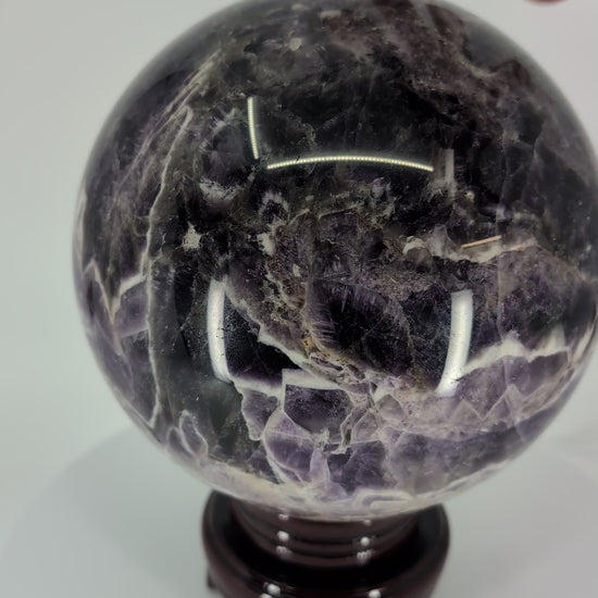 360° rotation video of Dream Amethyst sphere showing chevron pattern and polish