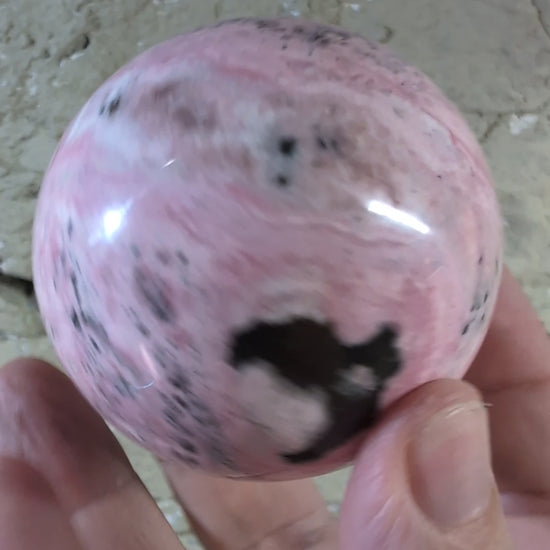 Video of 60mm 395g of polished pink rhodonite sphere with bold contrast