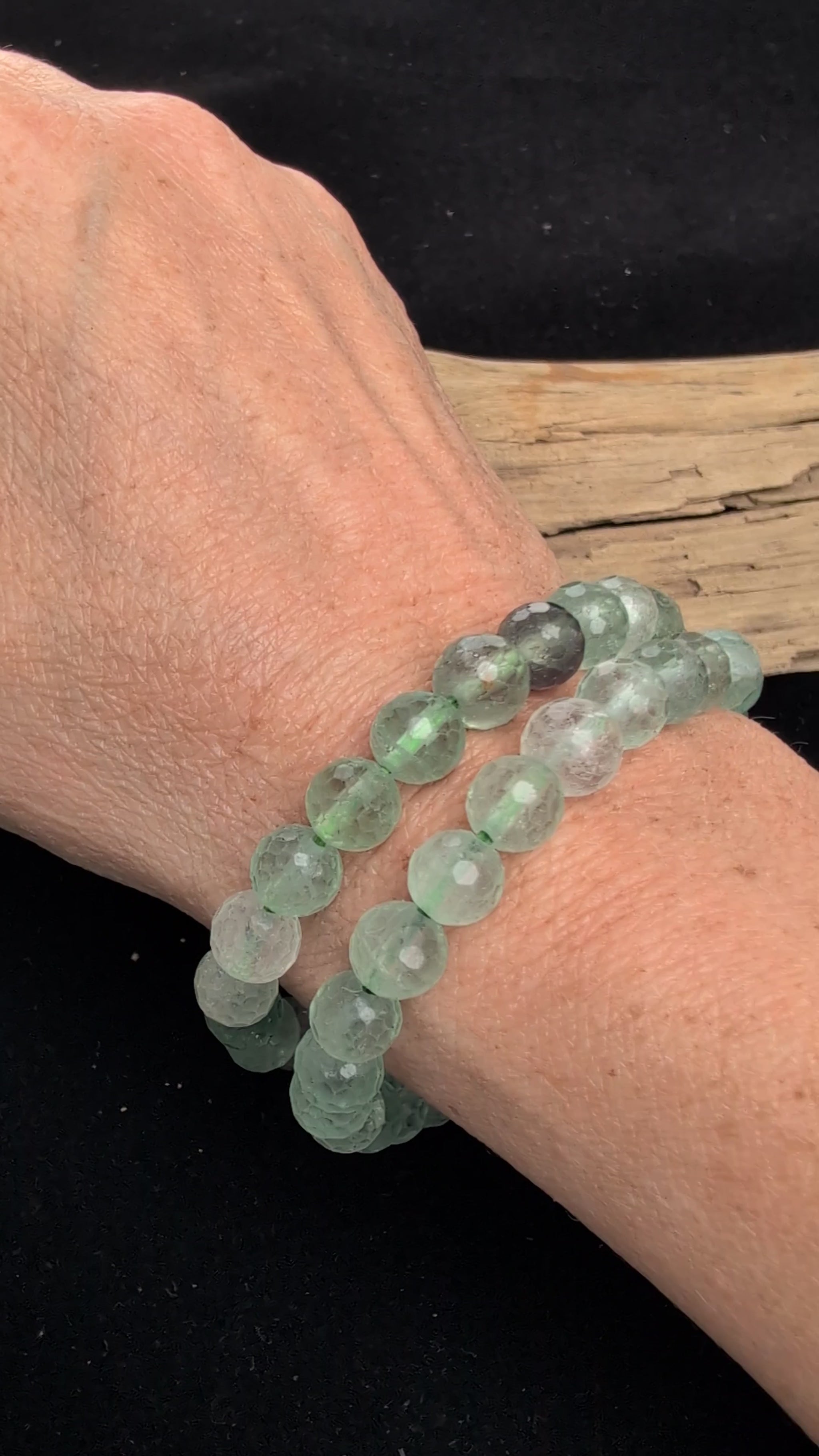 Video showcasing the highly reflective faceted texture, glassy lustre, and internal cleavage of both the green and mixed purple/green 8mm Fluorite beaded stretch bracelets worn on a wrist.