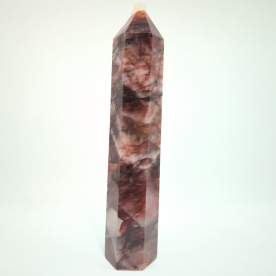 Video showcasing multiple Brazilian Fire Quartz towers in various sizes. Polished hematoid quartz points with fiery red hematite inclusions rotating under natural light.