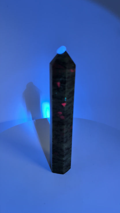 Ruby in Zoisite tower under UV light – fluorescent ruby sections
