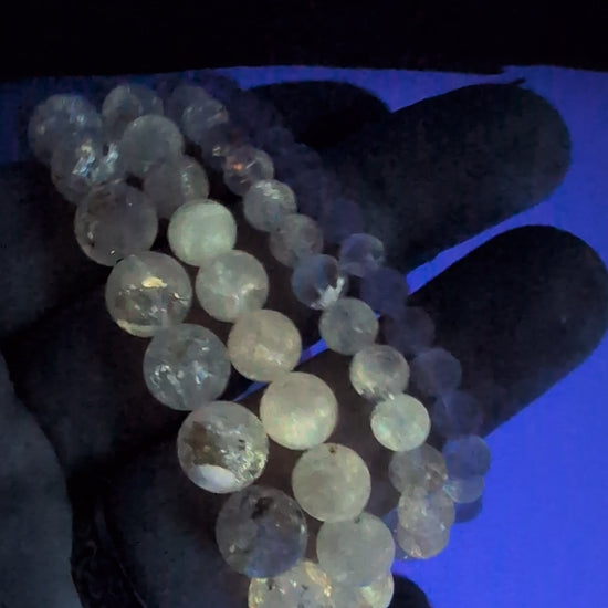 Video of Petroleum Quartz Bracelet glowing bright yellow under UV light with vivid fluorescence