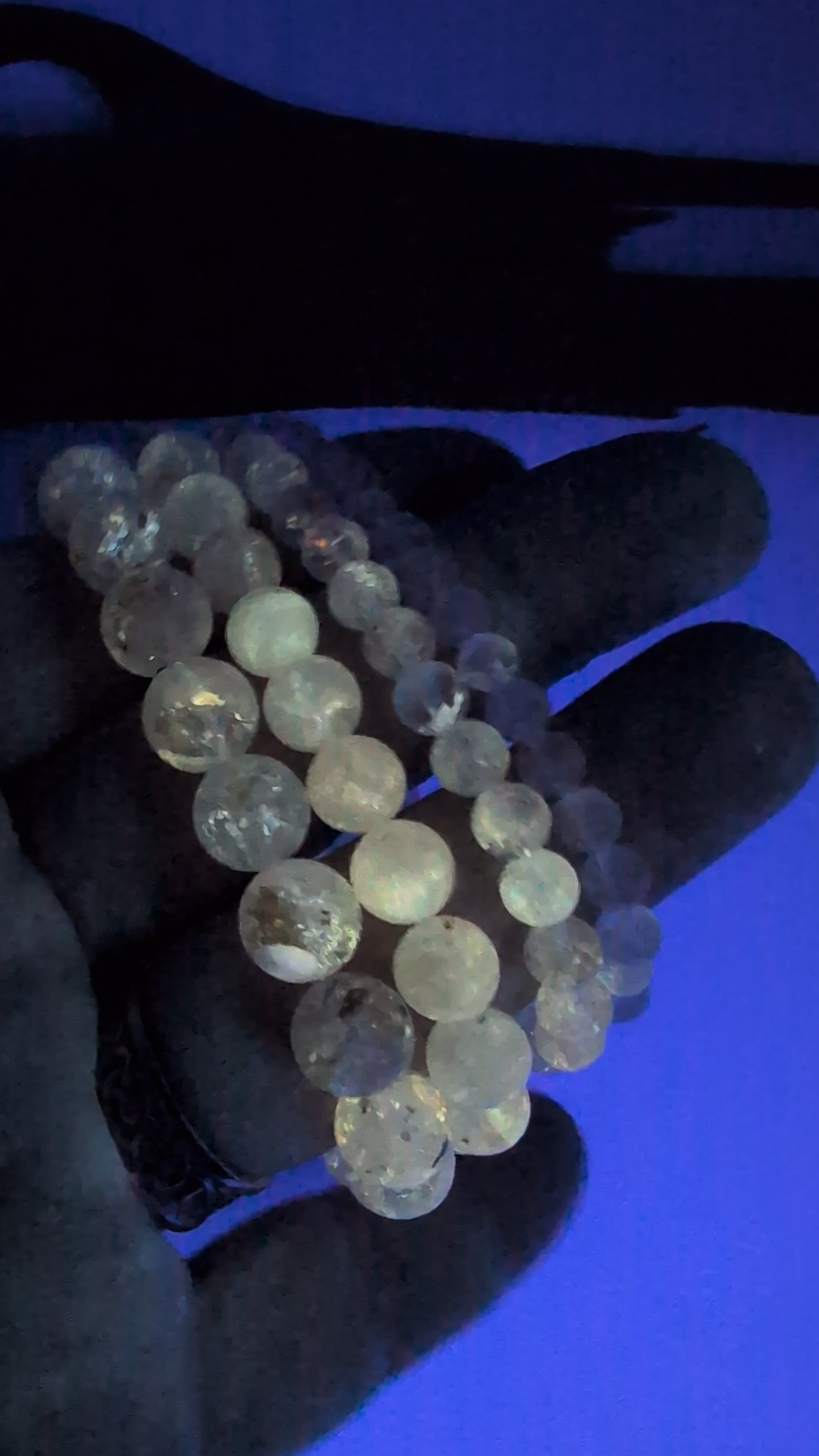 Video of Petroleum Quartz Bracelet glowing bright yellow under UV light with vivid fluorescence