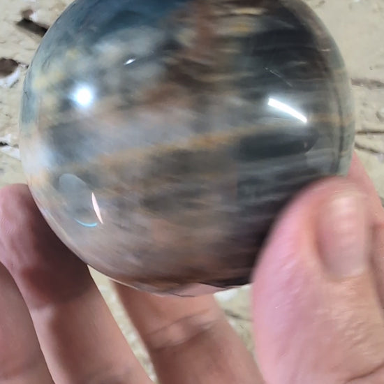 video of 63mm blue onyx sphere with banded patterns