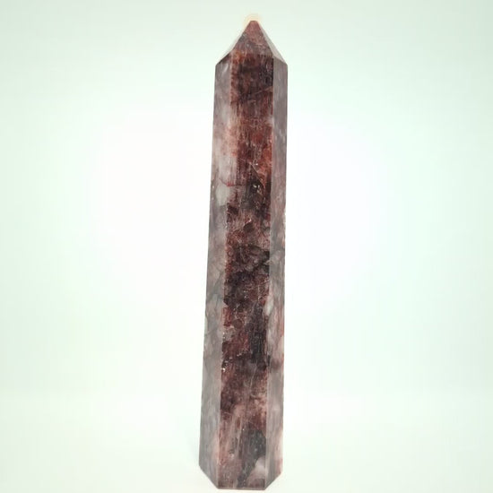 Video showcasing multiple Brazilian Fire Quartz towers in various sizes. Polished hematoid quartz points with fiery red hematite inclusions rotating under natural light.
