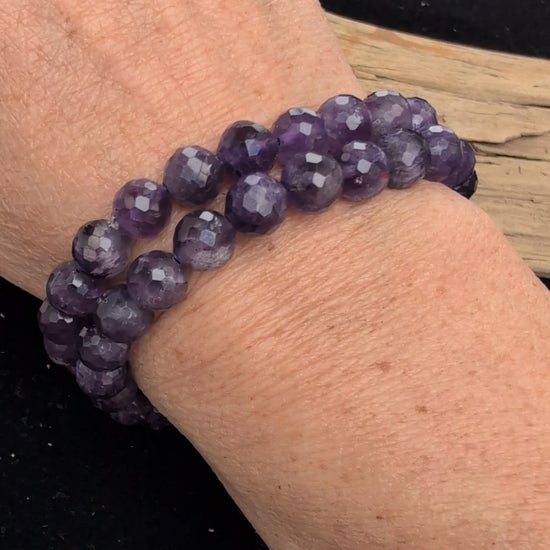 Video demonstrating the 8mm faceted Amethyst beaded stretch bracelet in motion, highlighting the light-catching geometric cuts and the deep purple colour saturation of the stones.