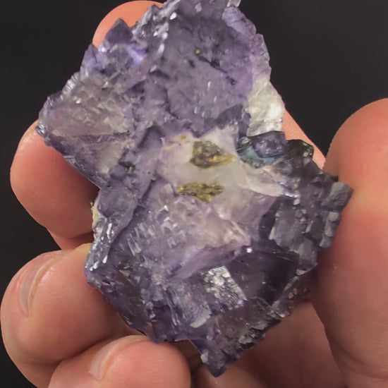 Rotating video of violet Elmwood fluorite with natural luster and UV fluorescence