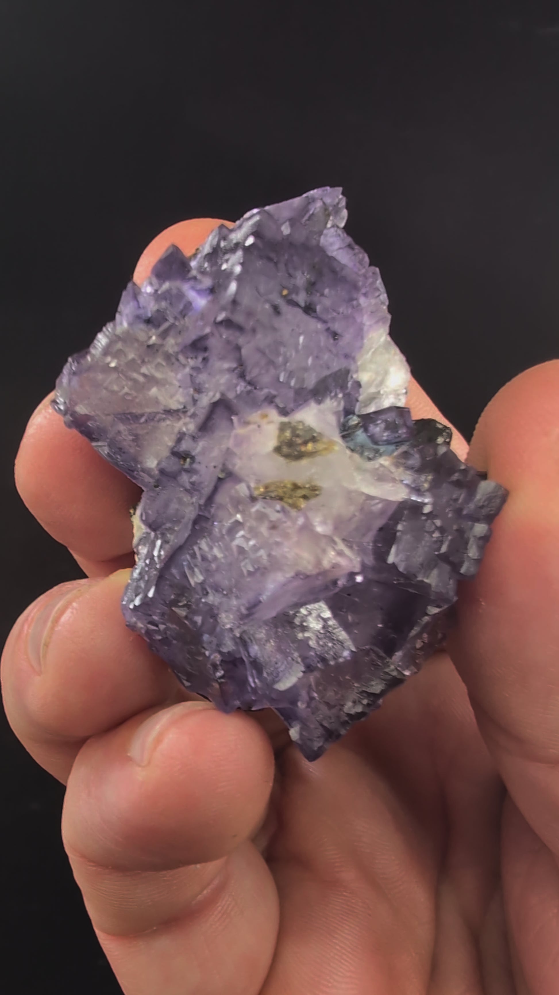 Rotating video of violet Elmwood fluorite with natural luster and UV fluorescence