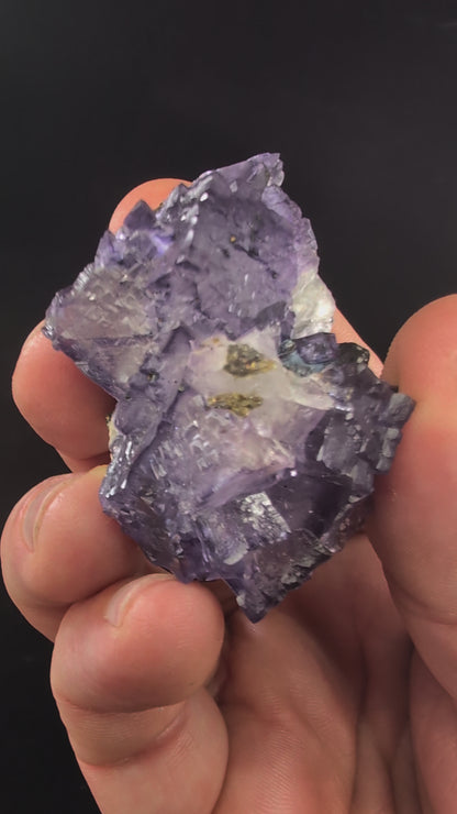 Rotating video of violet Elmwood fluorite with natural luster and UV fluorescence