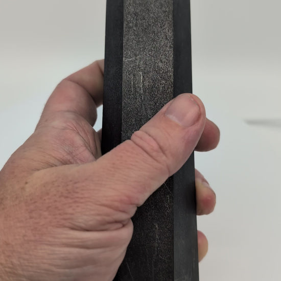 360° rotation video of large 500g polished Shungite tower showing deep matte-black sheen and geometric cut from Karelia, Russia.