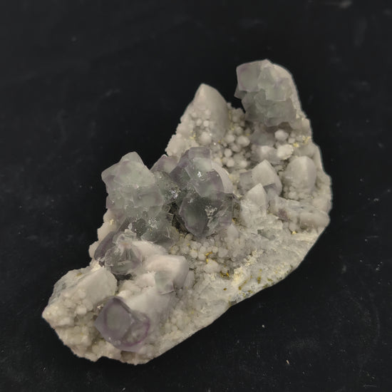 360-degree video of green window fluorite specimen on milky quartz, showing cubic zoning, surface brilliance, and UV fluorescence reaction
