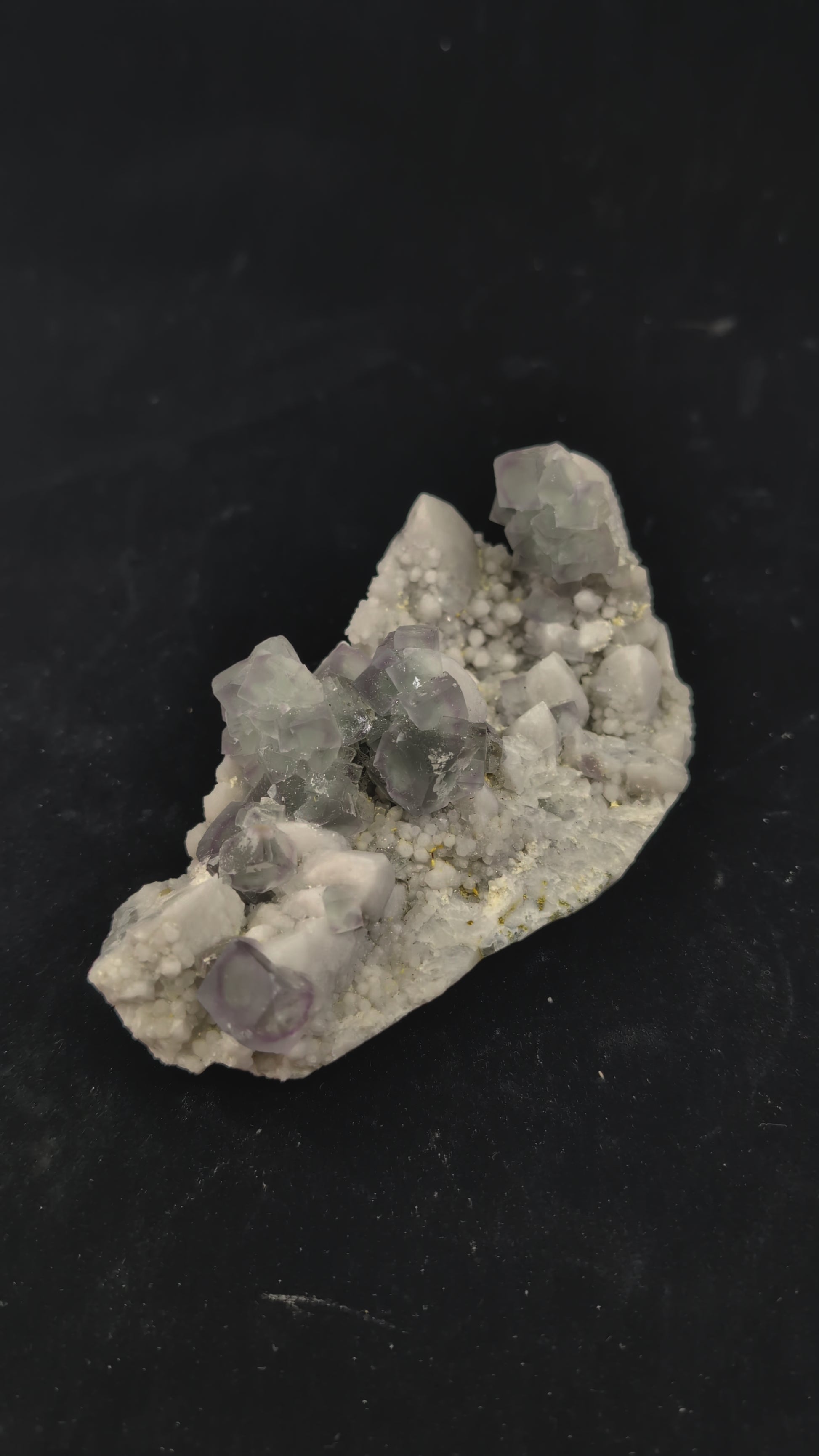 360-degree video of green window fluorite specimen on milky quartz, showing cubic zoning, surface brilliance, and UV fluorescence reaction