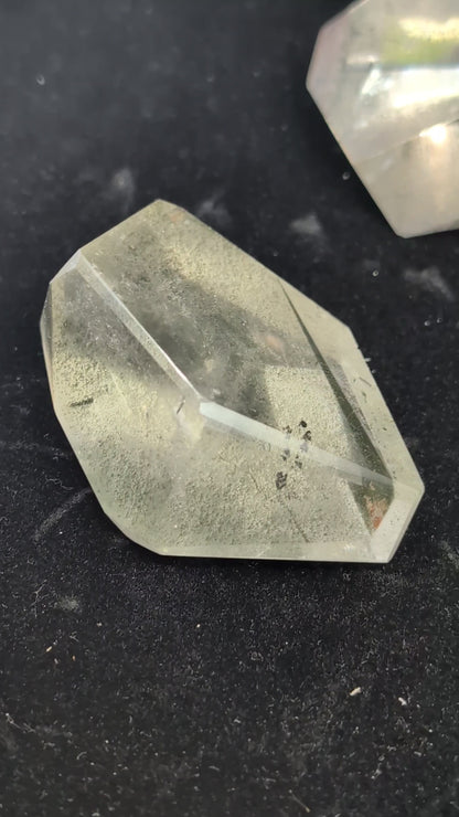 Video showcasing a collection of polished medium Garden Quartz faceted freeforms, highlighting their clarity and dense green and red internal mineral inclusions.
