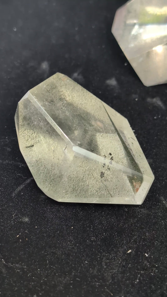 Video showcasing a collection of polished medium Garden Quartz faceted freeforms, highlighting their clarity and dense green and red internal mineral inclusions.