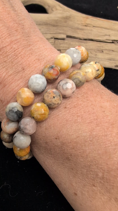 Video demonstrating the 8mm faceted Crazy Lace Agate beaded stretch bracelet in motion, highlighting the light-catching geometric cuts and the complex, multi-coloured natural banding and lace patterns across the stones.