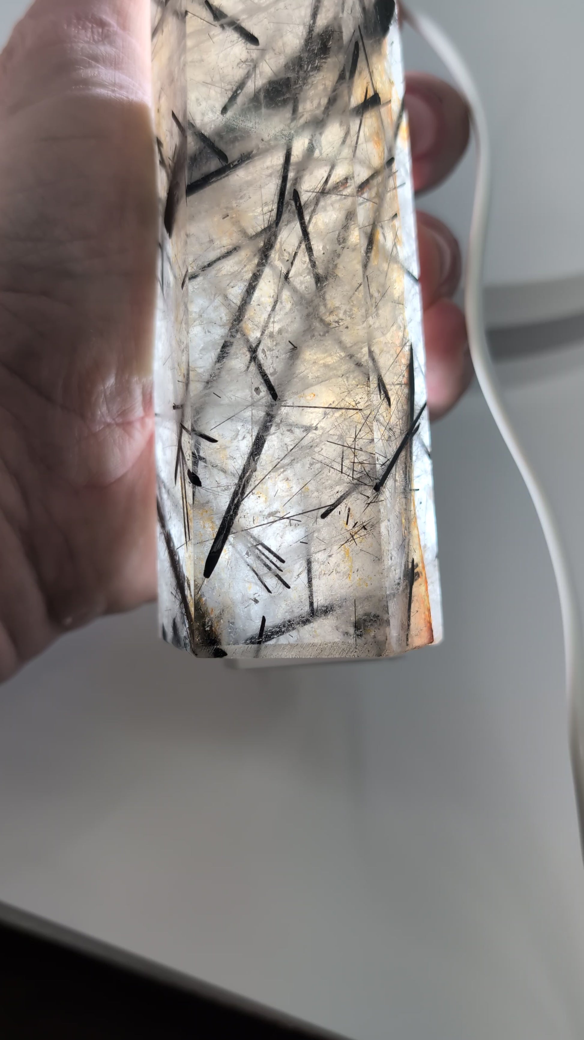 Black Tourmaline in Quartz tower illuminated from behind, revealing fine tourmaline needles and exceptional transparency.