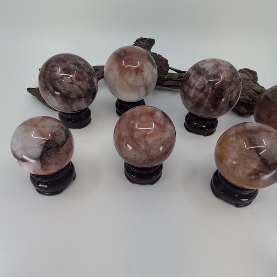 Exact-piece Brazilian Fire Quartz and Golden Healer (Limonite) crystal spheres. Expert mineral overview of hematoid quartz inclusions and natural clarity tiers.