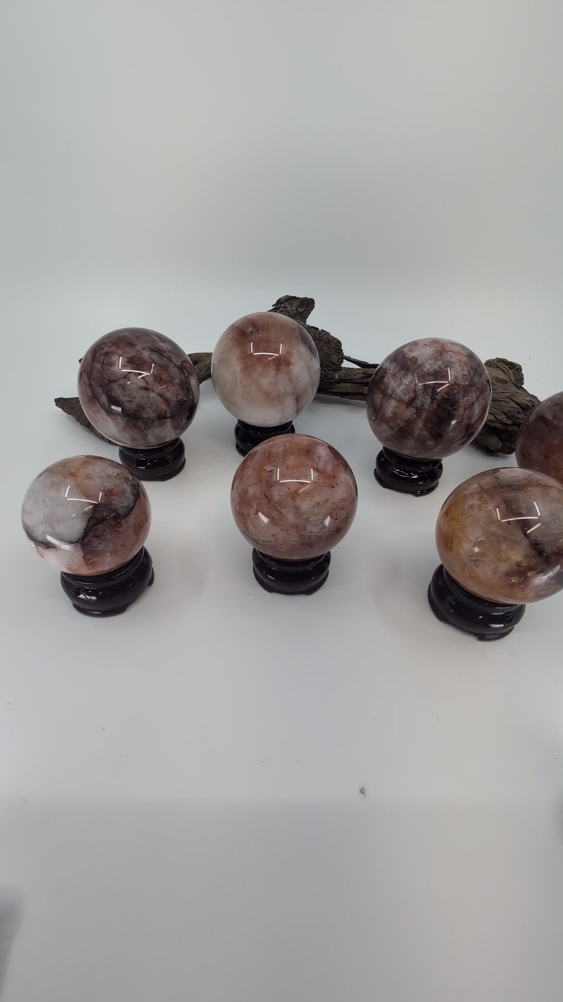 Exact-piece Brazilian Fire Quartz and Golden Healer (Limonite) crystal spheres. Expert mineral overview of hematoid quartz inclusions and natural clarity tiers.