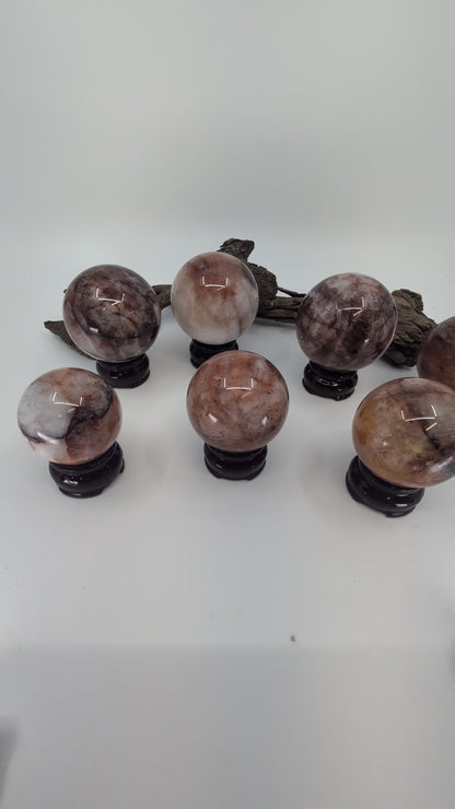 Exact-piece Brazilian Fire Quartz and Golden Healer (Limonite) crystal spheres. Expert mineral overview of hematoid quartz inclusions and natural clarity tiers.