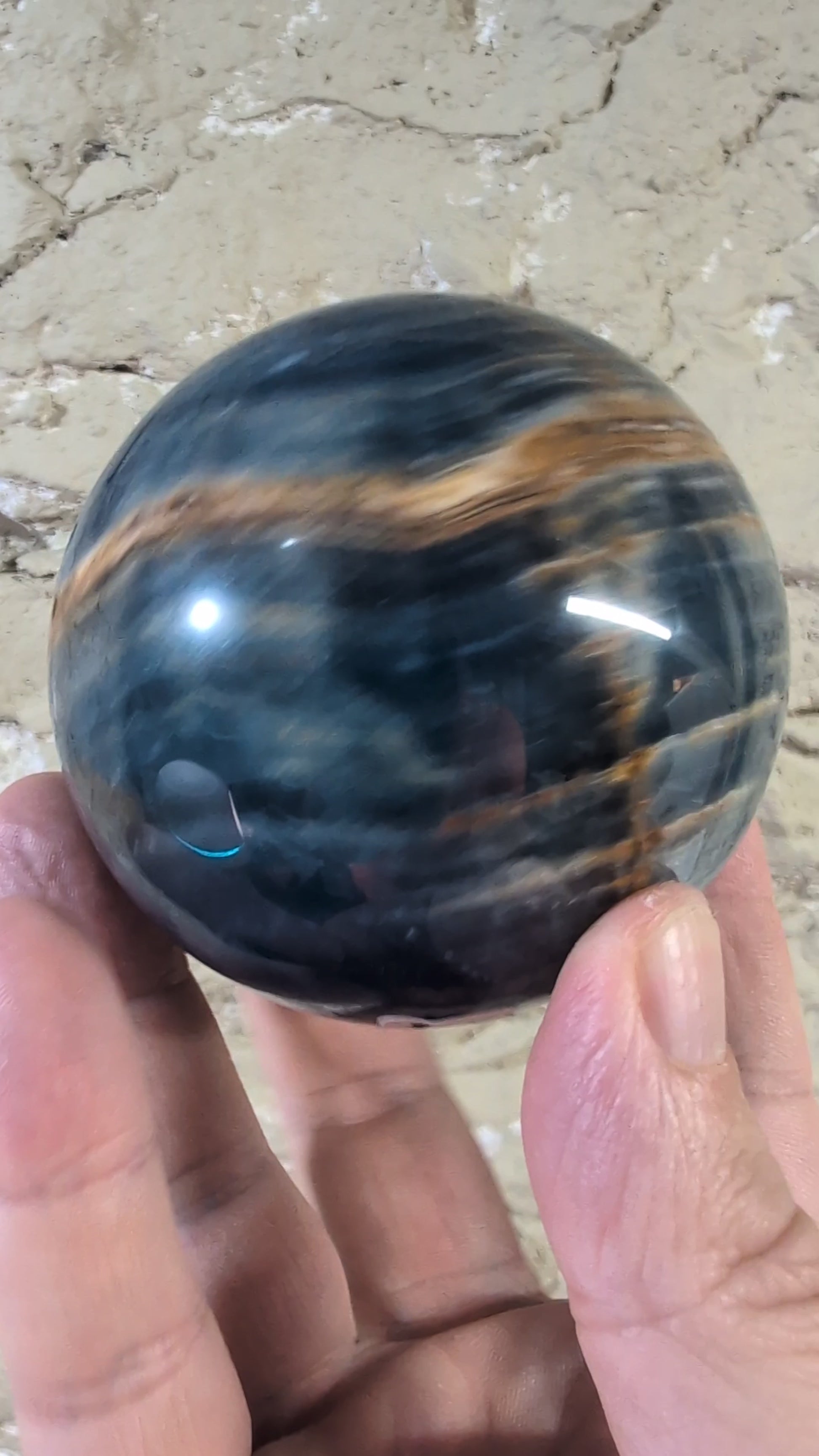 360° video of blue onyx sphere showcasing golden bands and deep blues