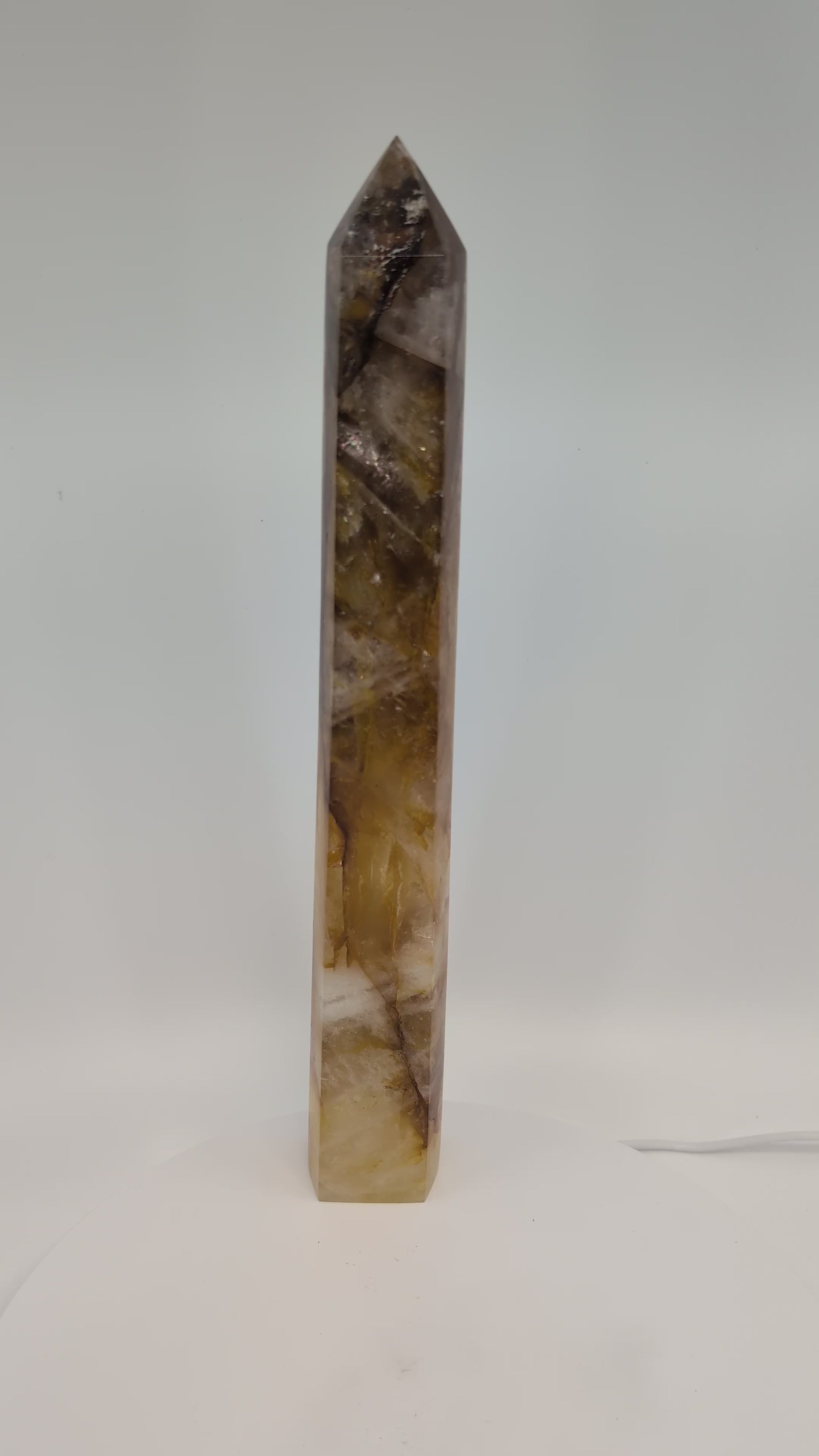 Golden Healer Quartz Tower 1.02 kg from Brazil rotating under natural light, showing golden zoning and sharp polished termination.