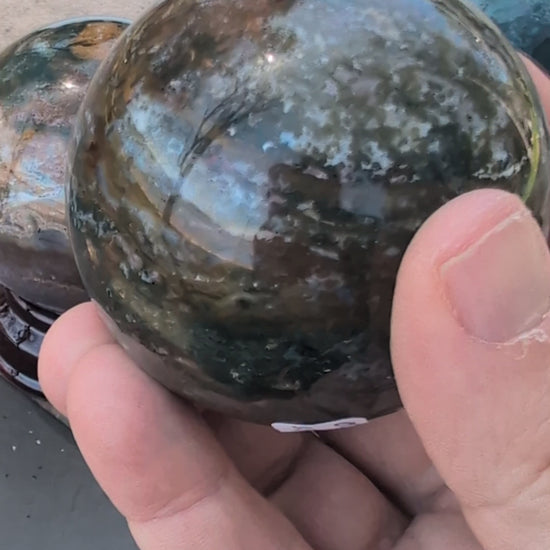 Showcase video of seven AA-grade Ocean Jasper spheres from Madagascar, highlighting orbicular patterns and high-polish finish.