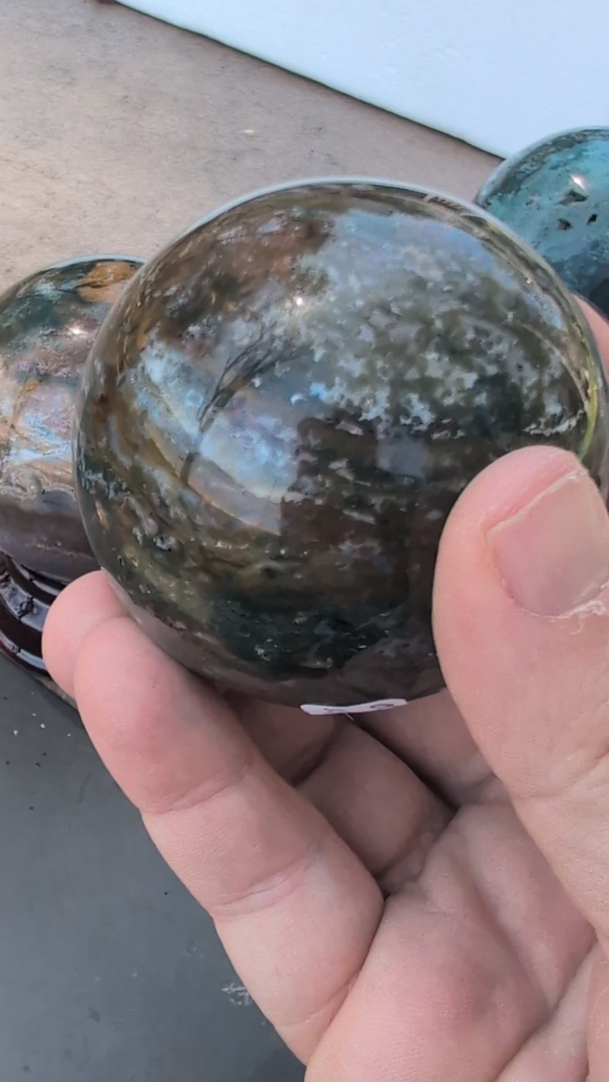 Showcase video of seven AA-grade Ocean Jasper spheres from Madagascar, highlighting orbicular patterns and high-polish finish.