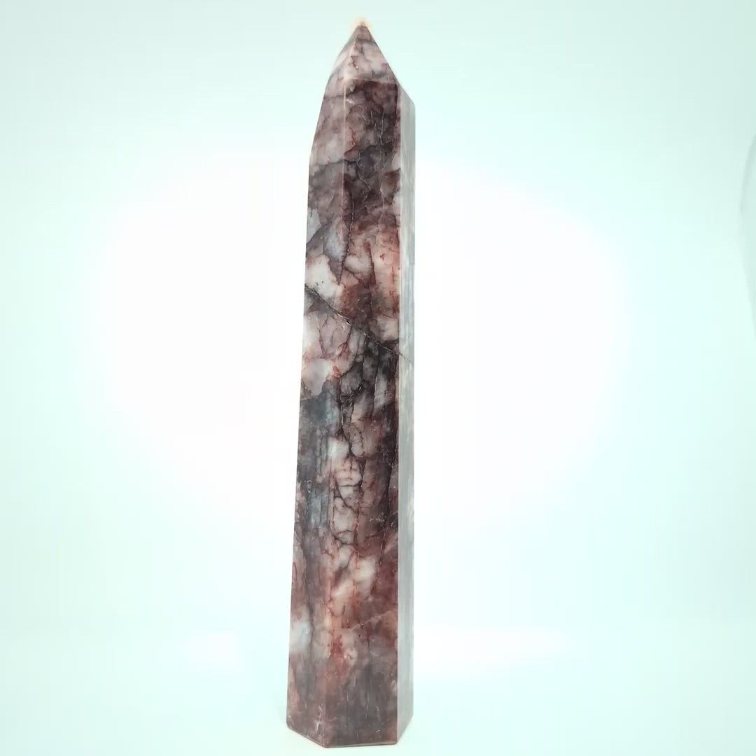 Video showcasing multiple Brazilian Fire Quartz towers in various sizes. Polished hematoid quartz points with fiery red hematite inclusions rotating under natural light.
