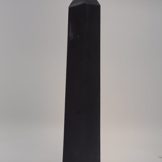Rotating clip of 360g Shungite tower emphasizing smooth polish, dark luster, and base details.