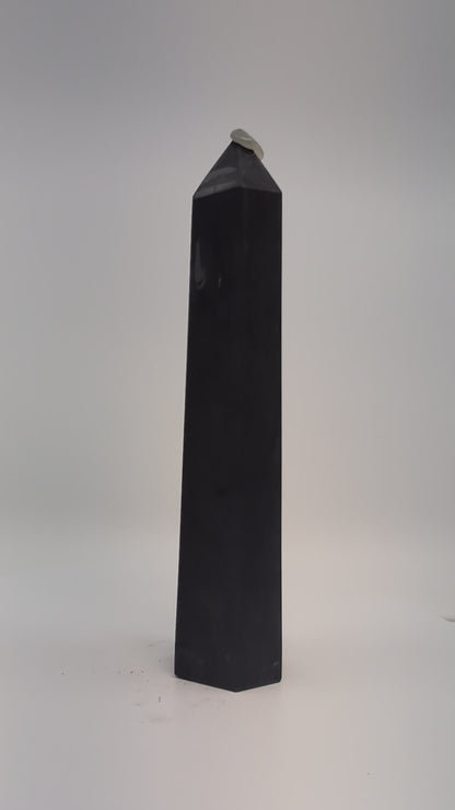 Rotating clip of 360g Shungite tower emphasizing smooth polish, dark luster, and base details.