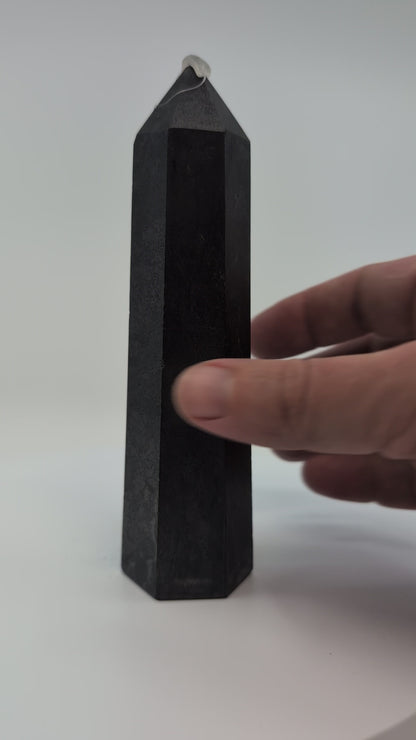 Video of slim 300g Shungite tower from Karelia, highlighting its smooth polish and sleek vertical profile under soft light.