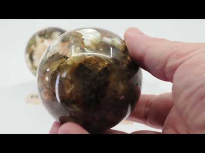 Video showcasing three Golden Mica (Phlogopite) spheres being rotated to reveal intense metallic chatoyancy, golden "flash," and layered crystal structures. Features Specimen A (470g), B (370g), and C (255g) on glass stands.