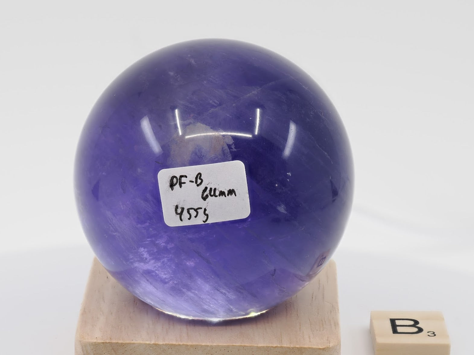 64mm Purple Fluorite sphere labeled PF-B with deep plum saturation and 455g weight.