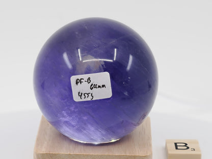 64mm Purple Fluorite sphere labeled PF-B with deep plum saturation and 455g weight.