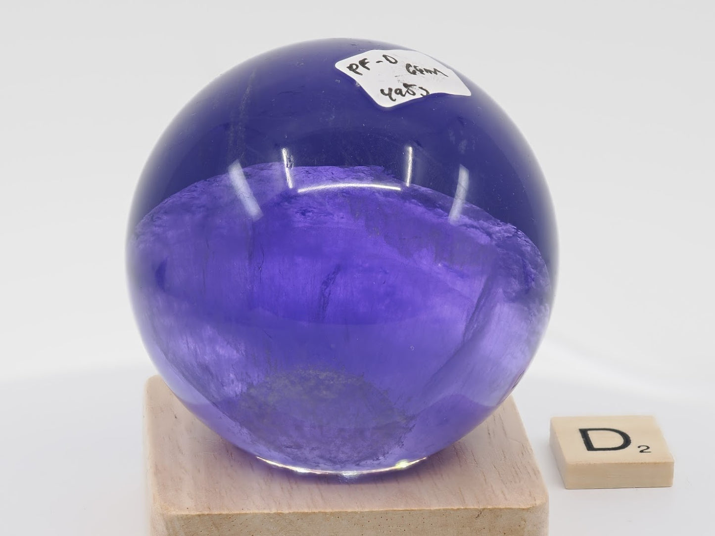66mm Purple Fluorite sphere showing a sharp split-color horizon boundary between indigo and lilac.
