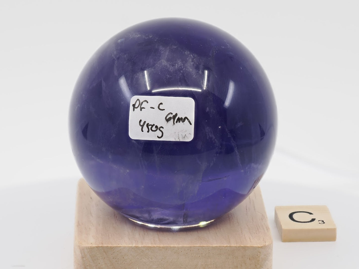 Largest 69mm Purple Fluorite sphere labeled PF-C with 450g weight and phantom chevrons.