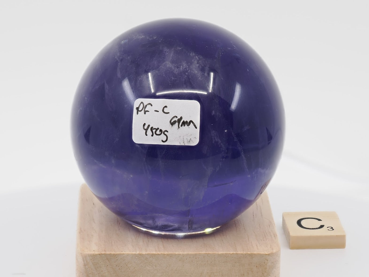 Largest 69mm Purple Fluorite sphere labeled PF-C with 450g weight and phantom chevrons.