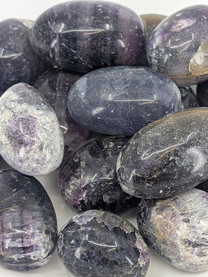 Close-up of Purple Fluorite tumbled stones showing color zoning